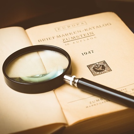 image of book with magnifying glass
