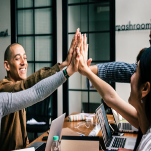 image of people giving high fives over computers