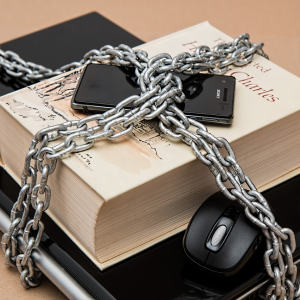 image of book and computer with chain around them