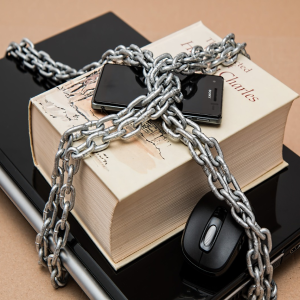 image of chained phone computer and book
